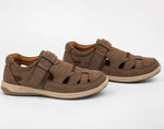 A pair of brown cut-sole sandals with hook-and-loop straps, displayed on a clean white studio background.